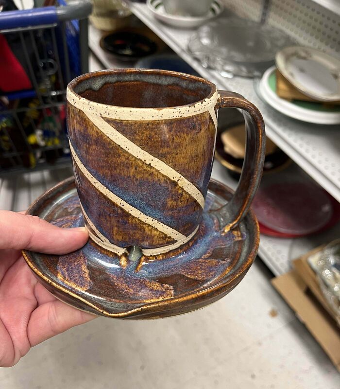 Hand holding a unique ceramic cup and saucer shaped object, featured in internet mystery of unidentified objects solved.