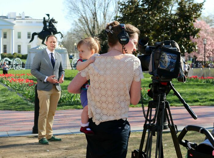 Female video journalist wearing headphones filming a man speaking outdoors, showcasing women in power tools and lab coats.