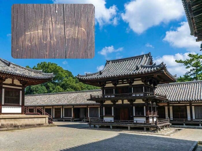Traditional Japanese temple with tourists' rude graffiti carved into wooden surface, highlighting entitled tourist behavior.