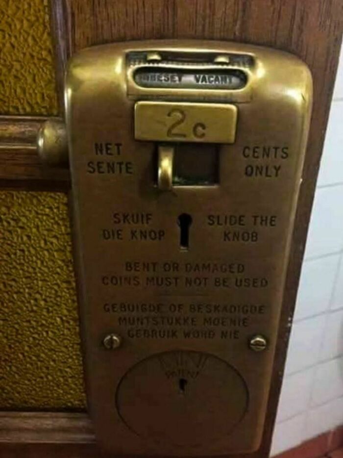 Vintage coin-operated door lock with 2-cent price, found in an abandoned home, showcasing disturbing and weird household items.