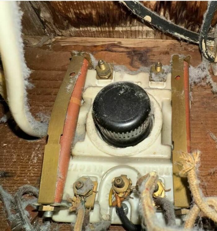 Old dusty electrical device with worn wires found among disturbing and weird things in abandoned homes.