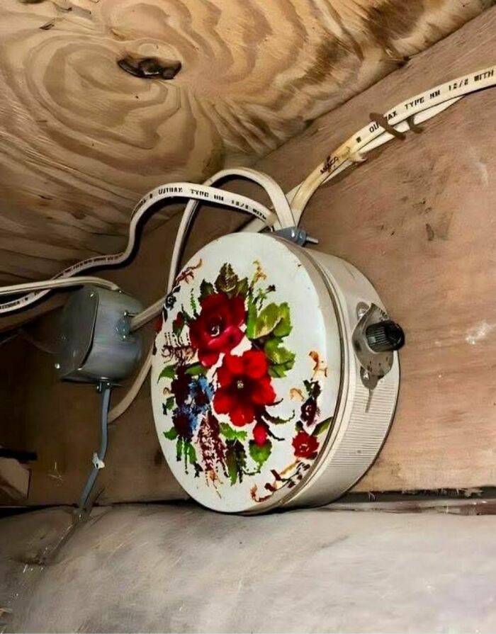 Vintage floral electric heater with old wiring inside an abandoned or forgotten home, showing disturbing and weird found objects.
