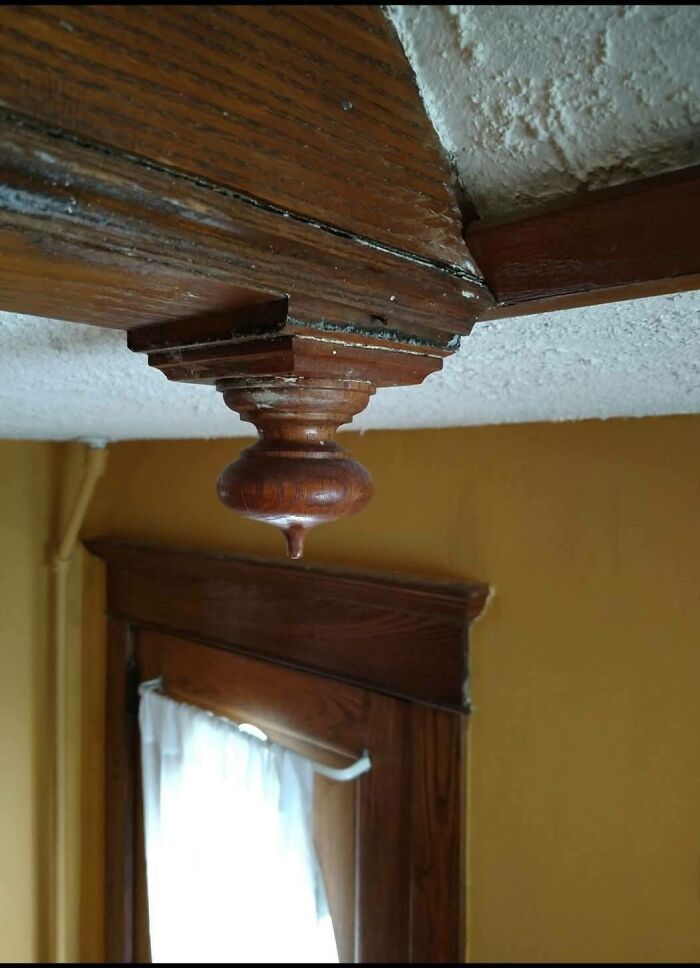 Wooden architectural detail on ceiling near window in abandoned home showing disturbing and weird things found indoors