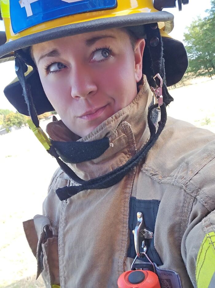 Female firefighter wearing protective gear and helmet, representing women choosing power tools and lab coats over manicures.