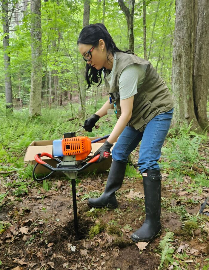 Woman using power tools outdoors in a forest, showcasing women in power tools and lab coats careers.