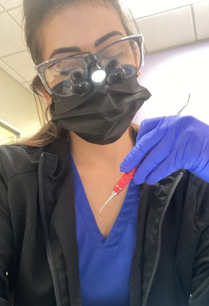 Woman in lab coat and magnifying glasses using dental tool, representing ladies choosing power tools and lab coats.