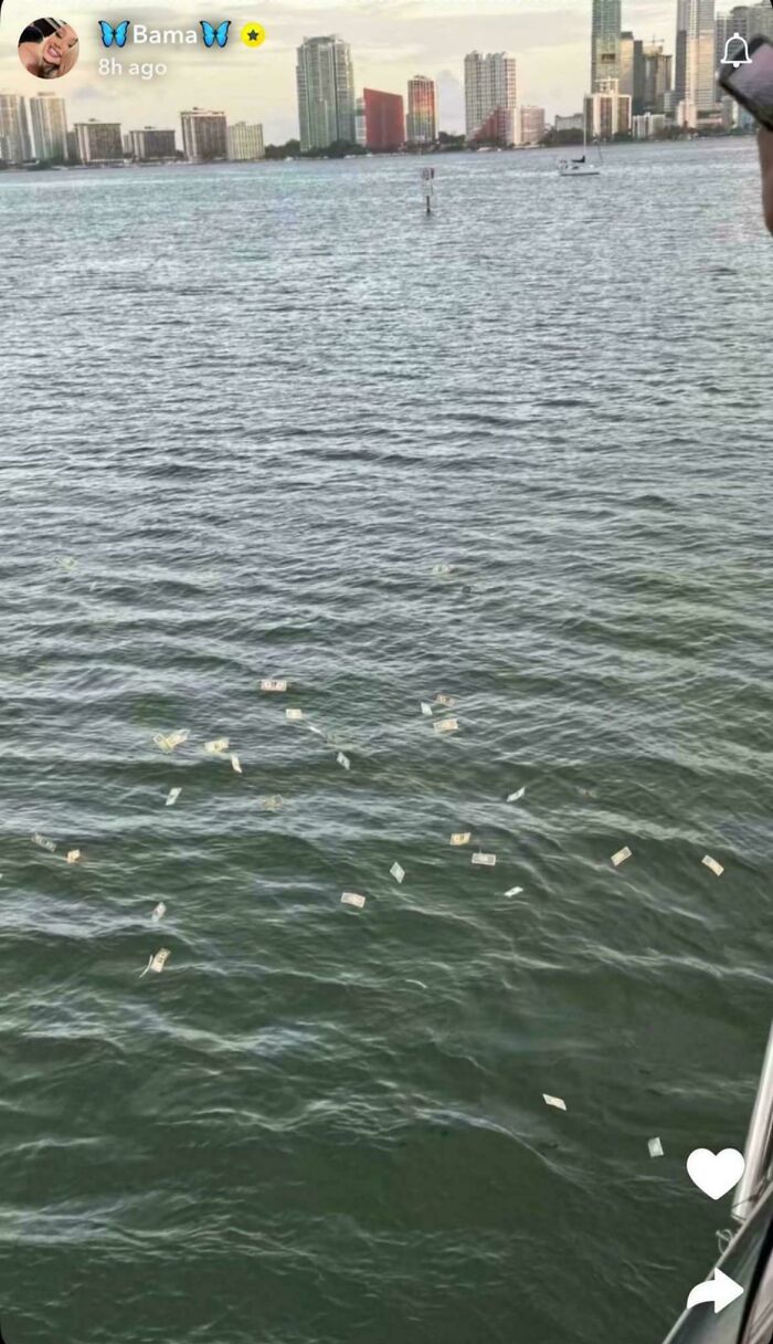 Influencers throwing money into the water near city skyline, showcasing cringy disregard for rules and common sense.