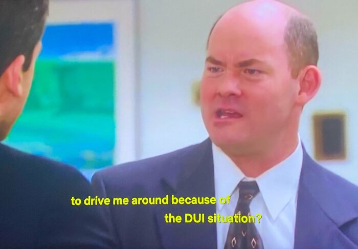 Man in a suit with a confused expression discussing a DUI situation in an old photo that aged badly.