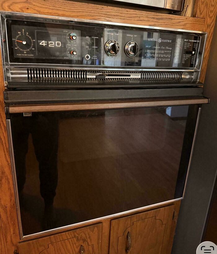 A vintage General Electric built-in oven with an analog clock and digital display showing 4:20. A true Buy It For Life purchase.