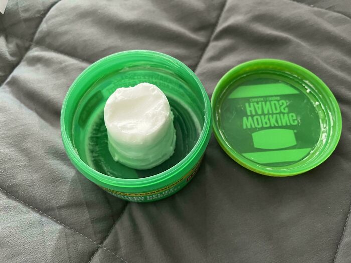 Mildly interesting pictures of a solid white block of product inside a green container, making you say huh.