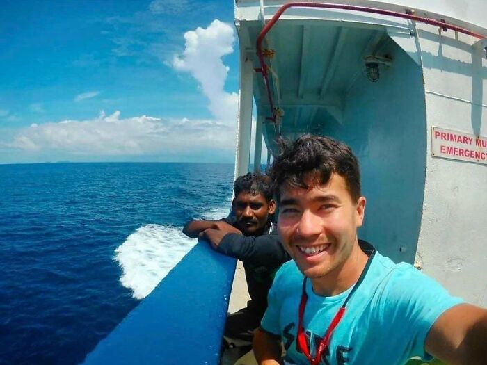 Two men on a boat smiling with ocean in the background morbid curiosity stories