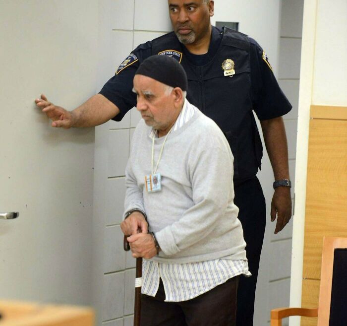 Elderly man with walking cane escorted by police in morbid curiosity stories image