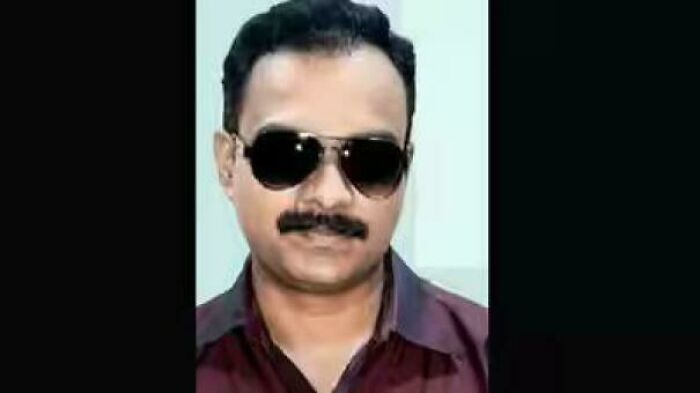 Man with mustache wearing sunglasses in a portrait photo