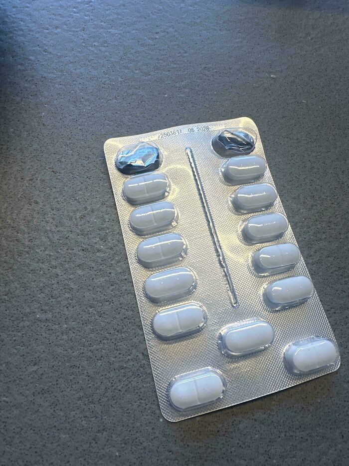 A blister pack of white oval pills with two missing, raising questions among baffling images.