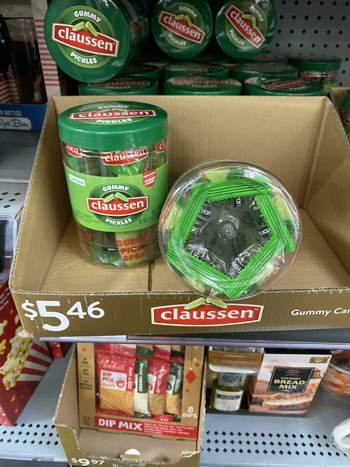 Claussen gummy pickles candy jars displayed on store shelf with price tag