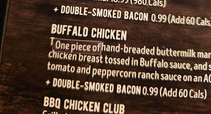 Buffalo chicken menu item with a typo in the word one highlighted on a dark menu board