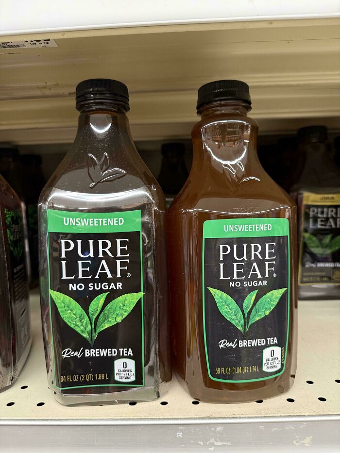 Two bottles of Pure Leaf unsweetened brewed tea with different sizes on store shelf