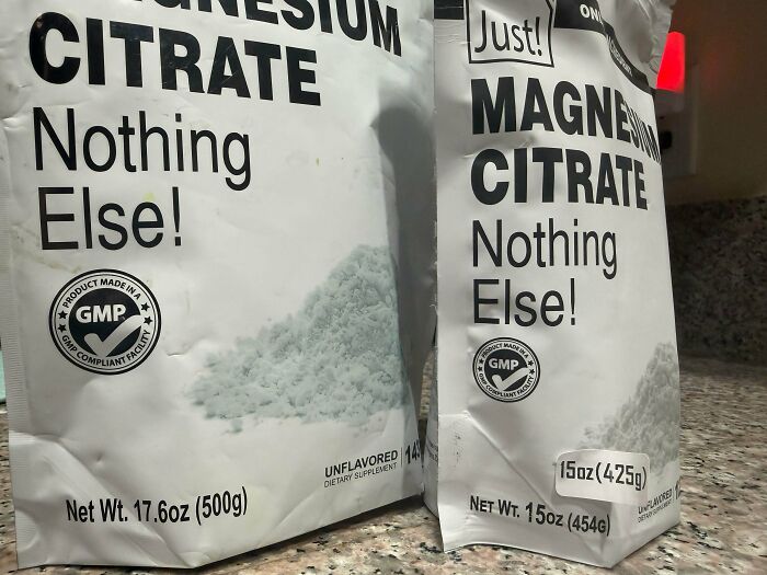 Two magnesium citrate supplement bags with different net weights on kitchen counter