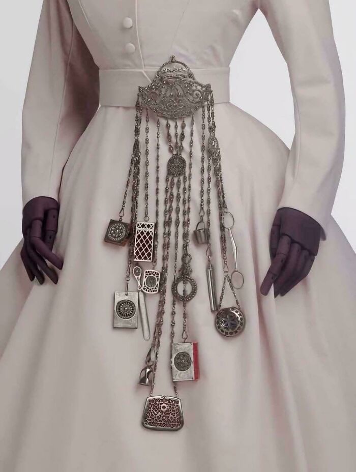 A Quintessential Chatelaine, 1863-1885 ~features; Scissors, Scent Bottle, Needle Case, Thimble Bucket, Small Cases, Letter Opener, Pinkeep, Cigar Cutter, Magnifier, Small Writing Tablet. Victoria & Albert Museum