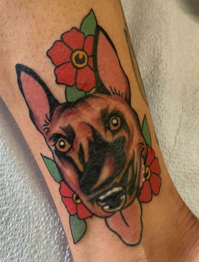 Dog portrait tattoo with flowers in a fail style