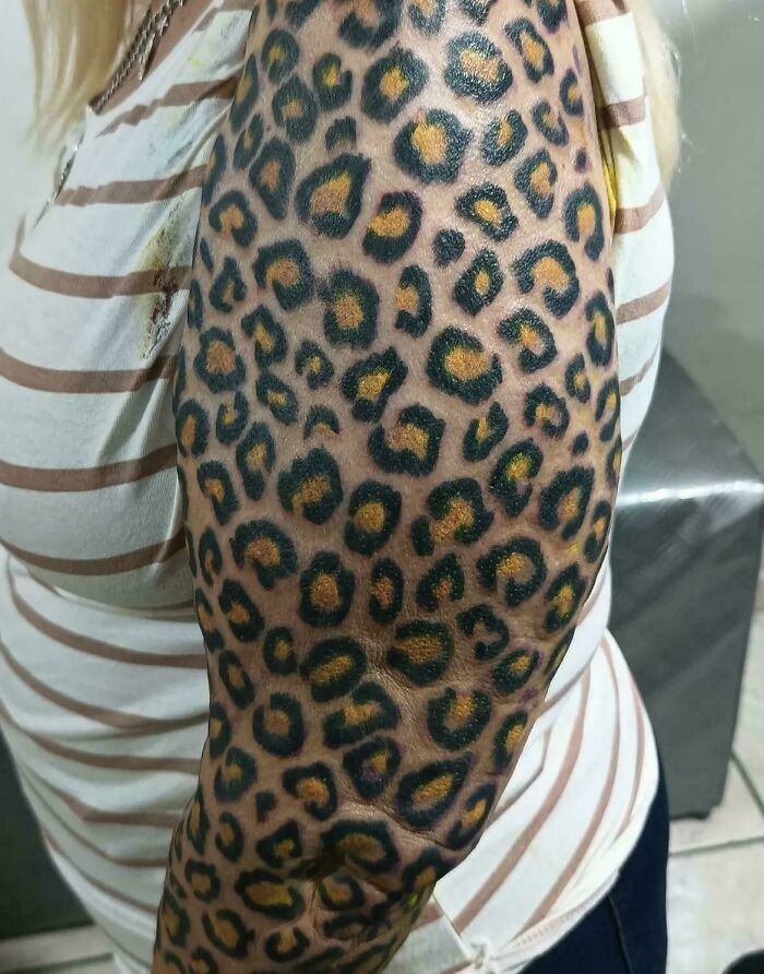 Leopard print tattoo fail on arm with uneven patterns