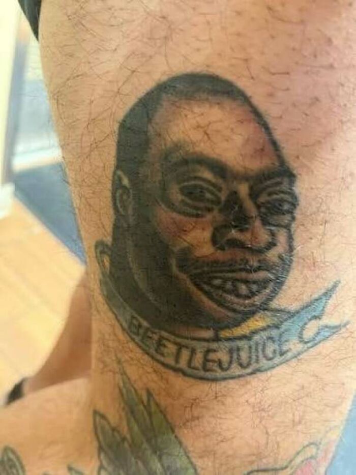 Haircut partially covering a neck tattoo with a sad face cartoon showing tattoo fails