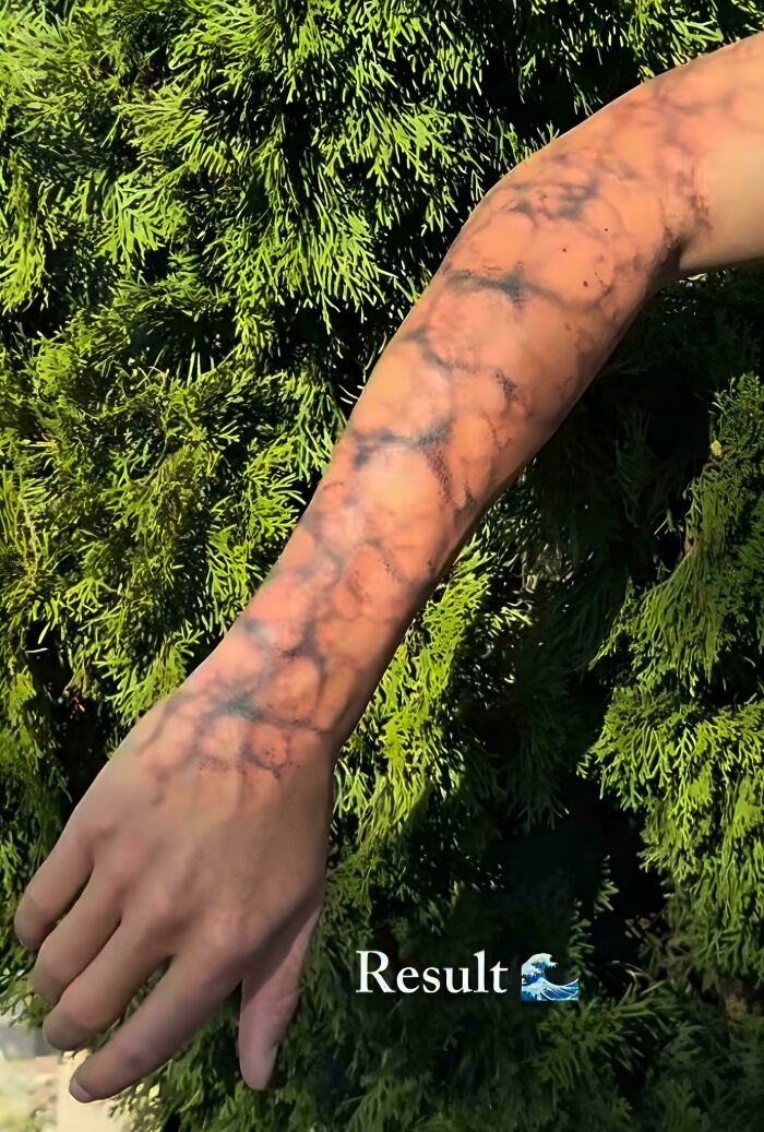 Arm tattoo with blurry, unclear patterns resembling a tattoo fail