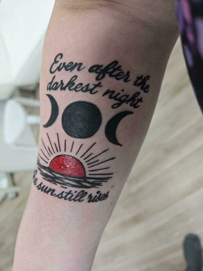 Tattoo fail with moon phases and red sun design on forearm