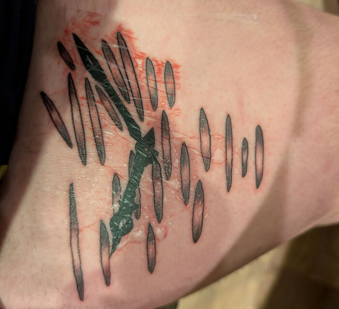 black dagger tattoo with distorted lines on skin