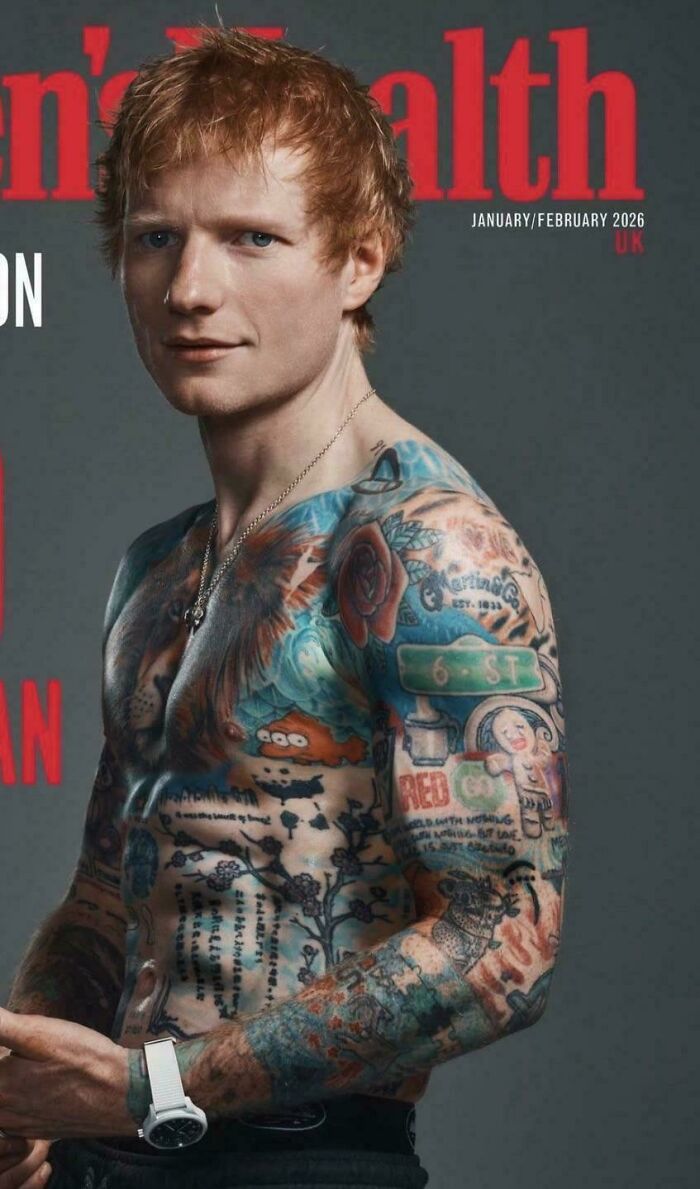 man with extensive colorful tattoos on chest and arms