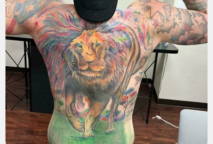 Colorful lion back tattoo with star patterns showing tattoo fail