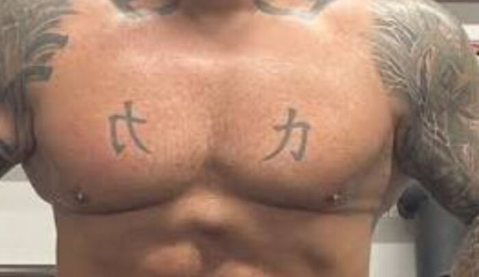 Chest tattoo with Asian characters showing tattoo fail