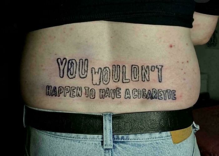 Tattoo fail with text on lower back reading you wouldn't happen to have a cigarette