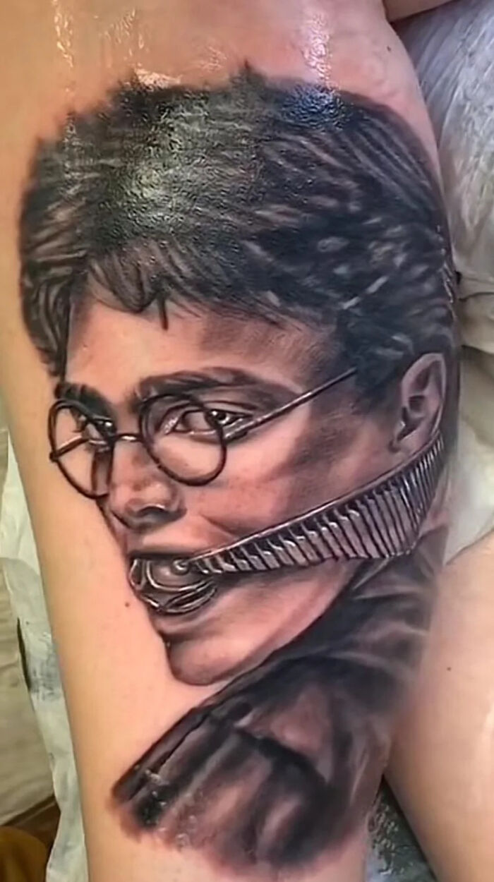 Tattoo fail showing a distorted portrait with zipper over mouth