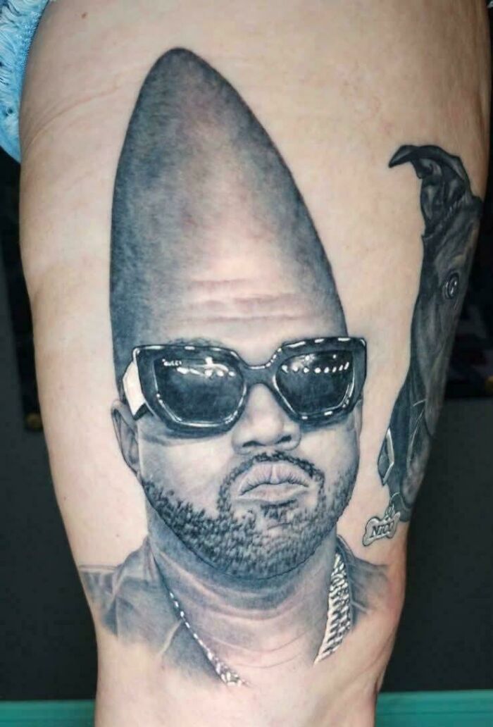 Tattoo of a man wearing sunglasses with an exaggerated tall head
