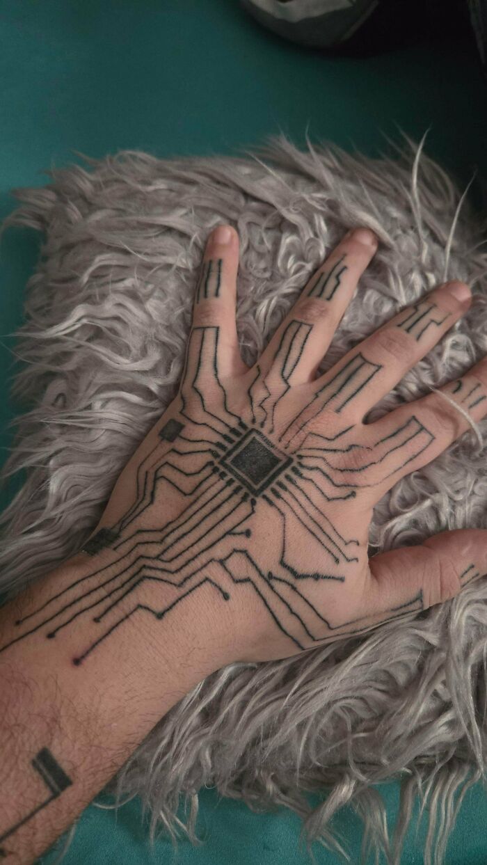 Hand tattoo fail with circuit board design lines and irregular patterns