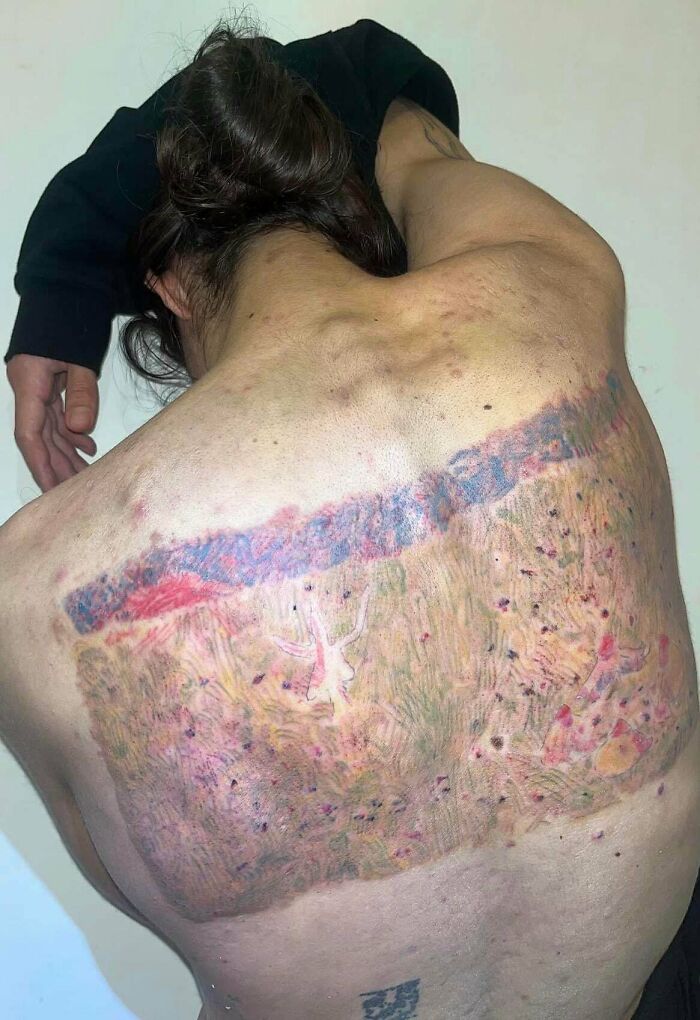 Faded and blurry colorful back tattoo with unclear design tattoo fails