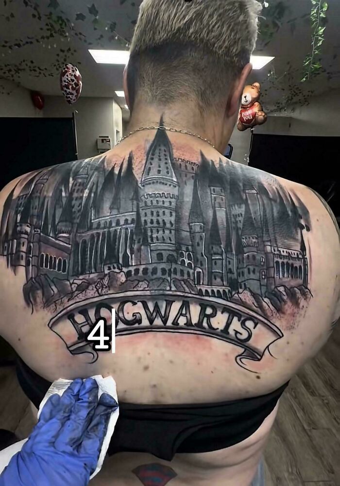 Large back tattoo of Hogwarts castle poorly inked tattoo fails