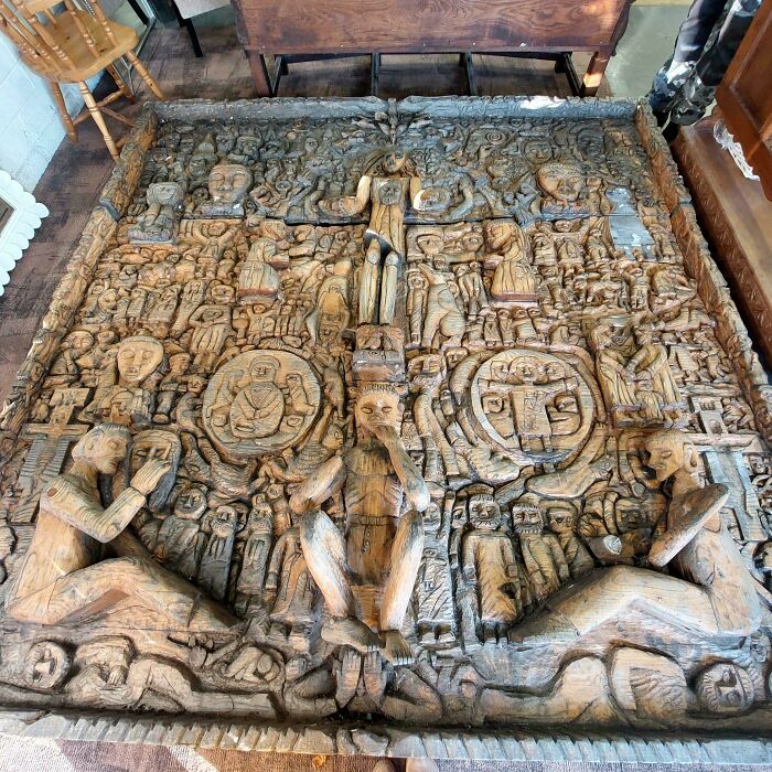 An intricately carved, large wooden panel displaying various figures, a truly remarkable antique piece.