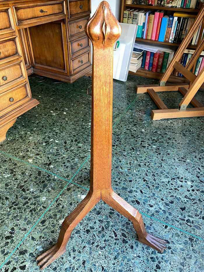 Remarkable antiques: A unique wooden stand with duck-like feet and a decorative top, found in a home.