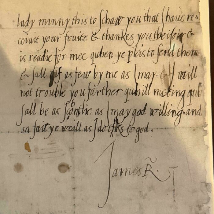 Old handwritten letter on parchment featuring calligraphy and signature from historical era