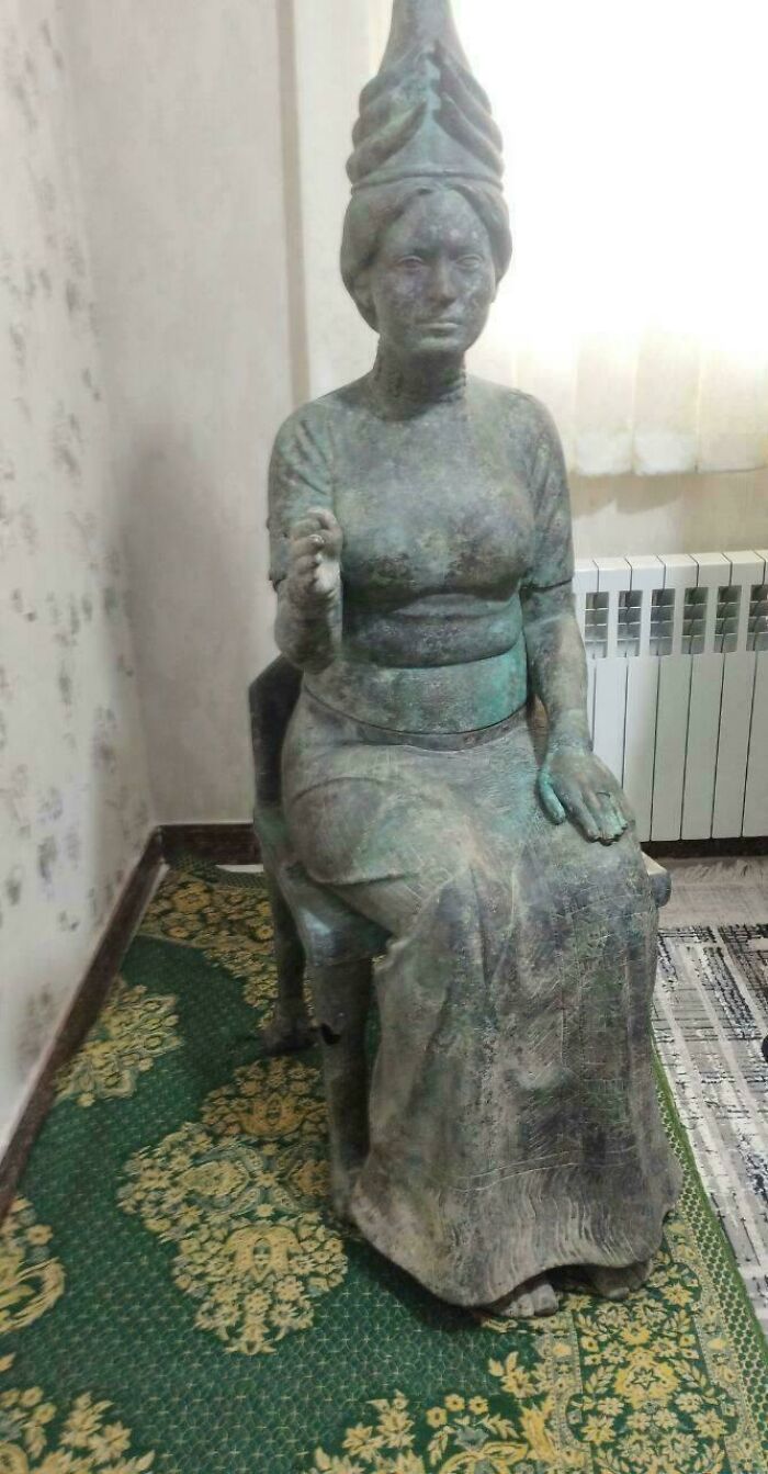 Ancient seated statue with detailed headdress and robes from incredible discoveries era