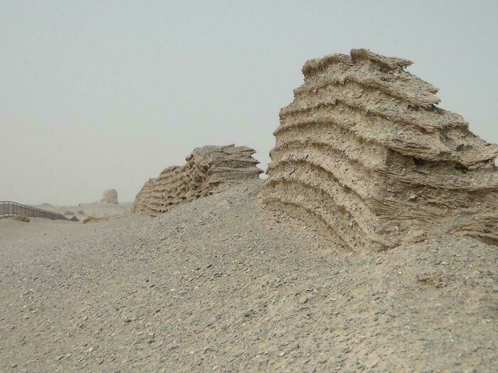 Ruins of ancient mud-brick walls eroded by desert elements