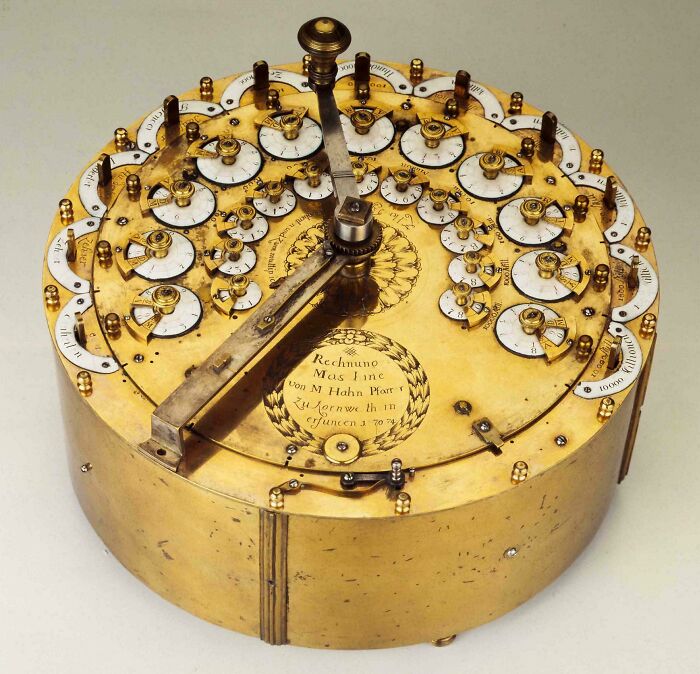 Antique mechanical calculator with intricate dials and brass construction discovery