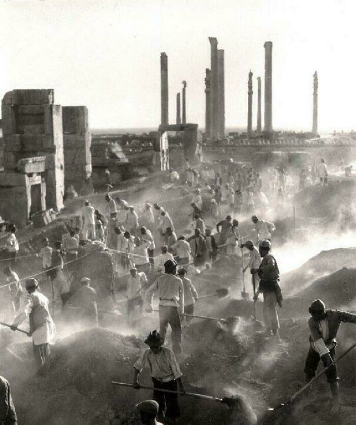 Historic black and white photo of workers excavating an ancient archaeological site