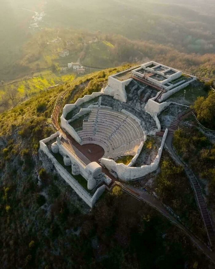 Ancient stone amphitheater ruins discovered on a hillside revealing historical architecture