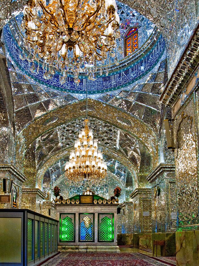 Ornate mirrored shrine interior with colorful stained glass window discovery
