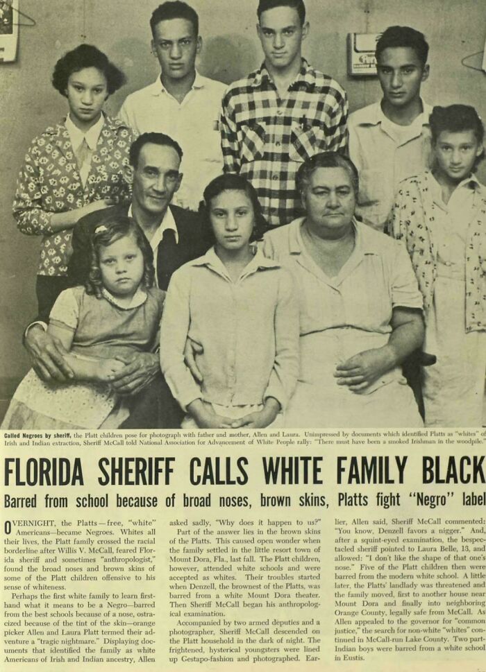 A large family, including children and adults, poses for a historical photo that tells a powerful story.
