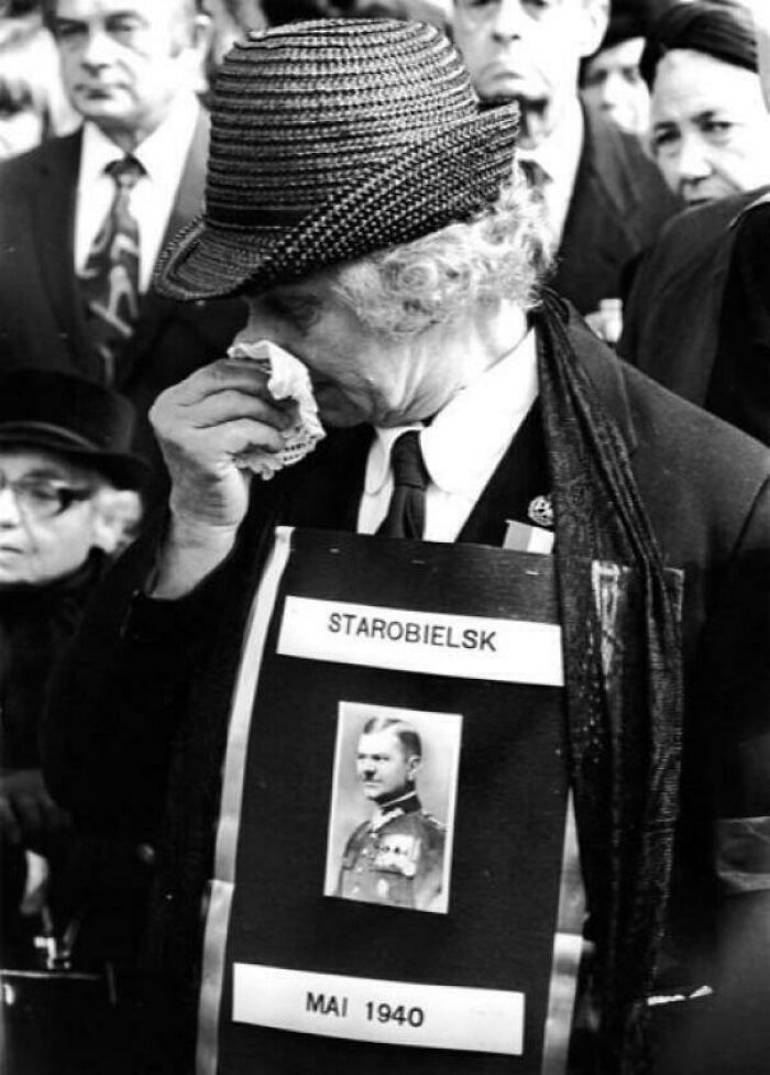 Emotional historical photo of a woman in a hat crying, holding a sign for Starobielsk Mai 1940, reflecting the past.