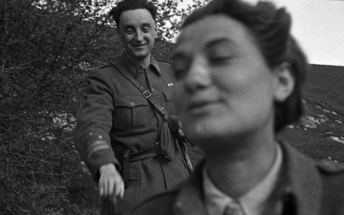 A blurry close-up of a woman with a man smiling in the background, one of many emotional historical photos
